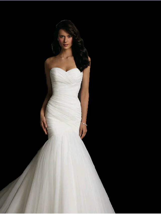 Side profile of the white strapless tulle wedding dress with ruched details.