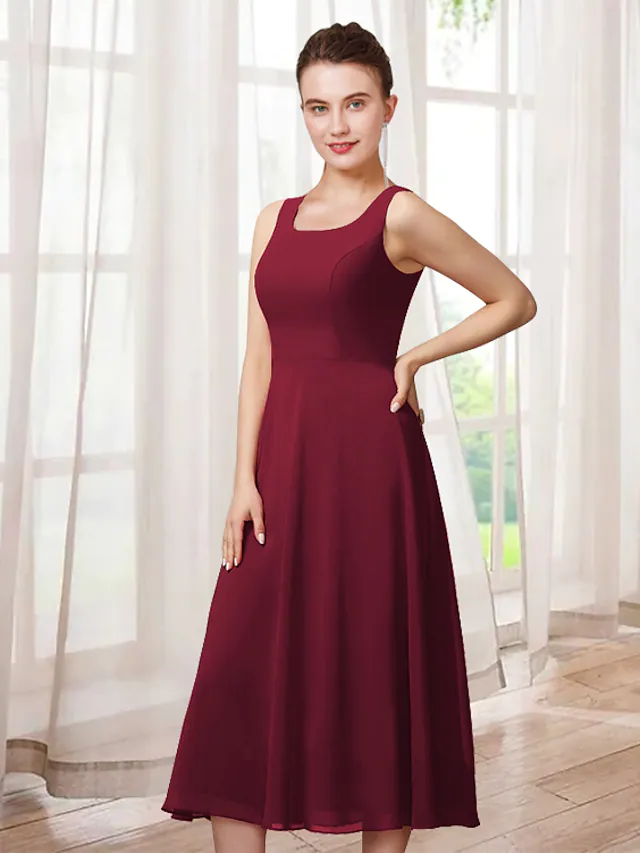 Elegant two-piece A-line mother of the bride dress with jewel neck, 3/4 sleeves, and lace appliques.