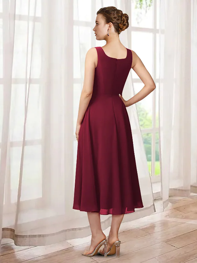 Back view of the two-piece A-line mother of the bride dress showing tea length and flowing chiffon.