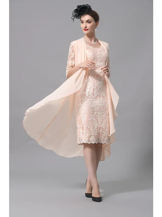 Close-up of the lace half sleeves and appliques on the dress.