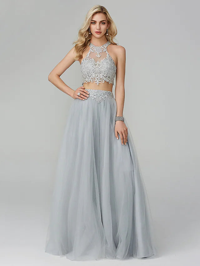 Close-up of the halter neckline and intricate lace appliques on the formal dress.