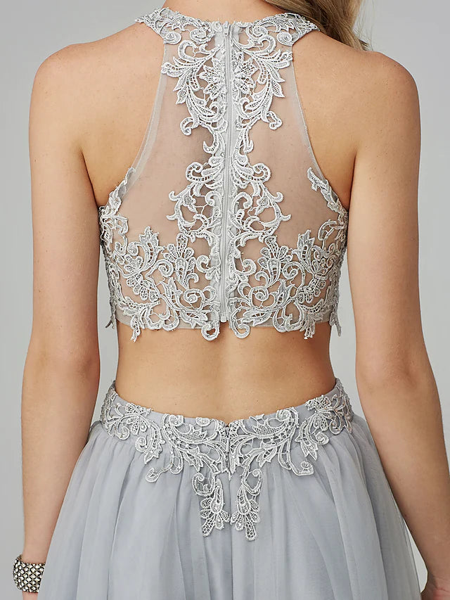 Full length view of the two-piece prom dress with a flowing skirt.