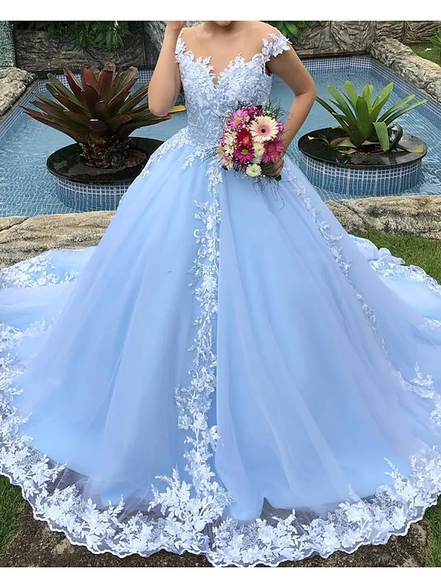 Side profile of a plus size bridal gown with a flowing ball gown skirt.