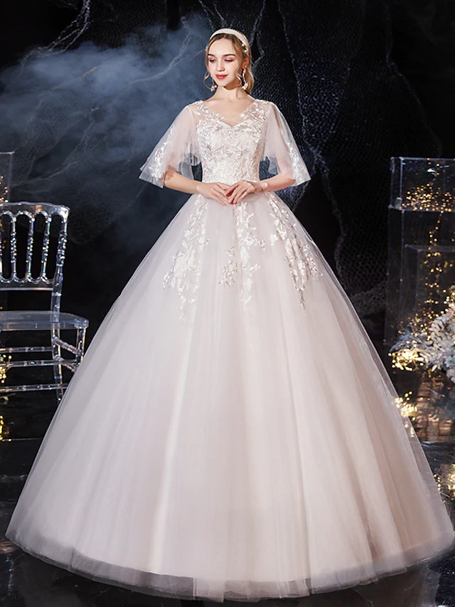 Elegant V-neck ball gown wedding dress with lace and tulle.