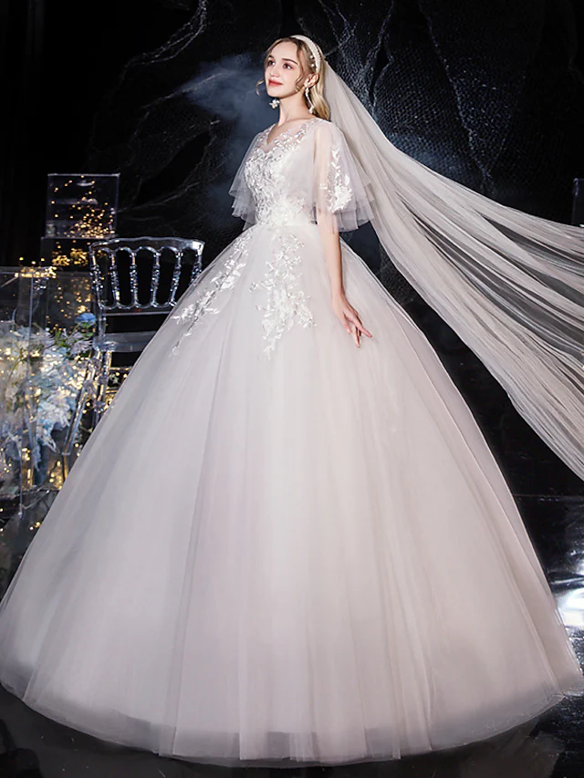 Side view of lace and tulle half sleeve wedding dress.