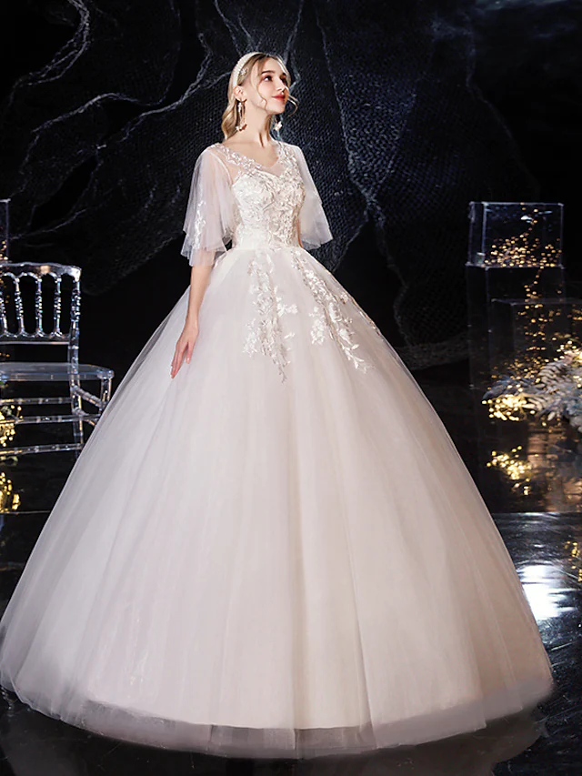 Detail of half sleeves and V-neck on wedding gown.