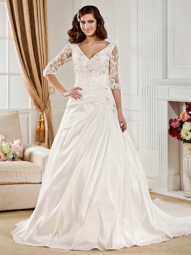 Elegant V-neck ball gown wedding dress with half sleeves.