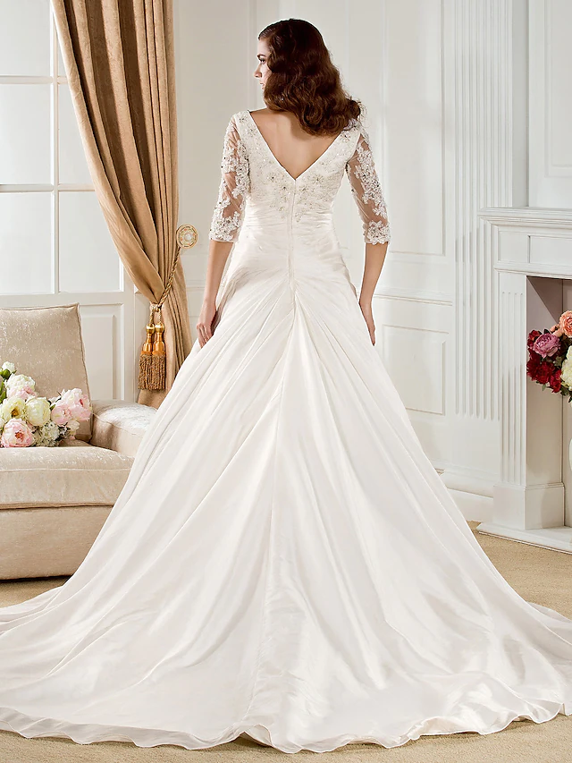 Side view of the bridal gown showing the chapel train.