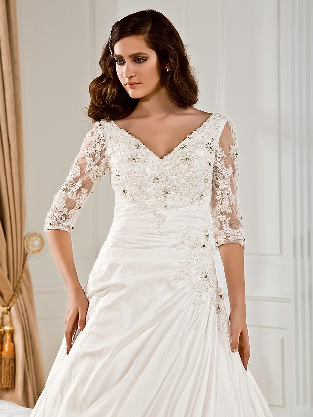Bridal gown with chapel train and intricate beading.