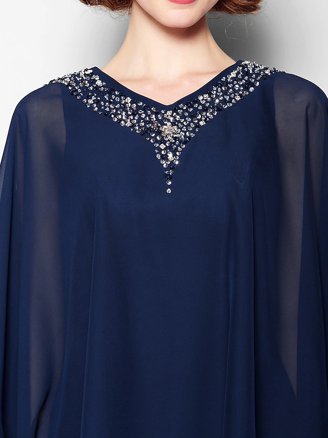 Close-up of the crystal beading detail on the bodice of the chiffon dress.