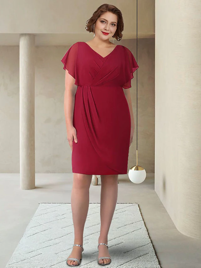 Back view of the elegant chiffon dress, highlighting the silhouette and short sleeves.