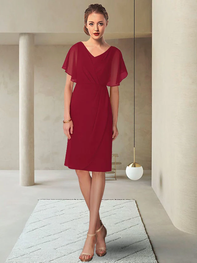 Close-up of the V-neckline and ruched bodice on the chiffon mother of the bride dress.