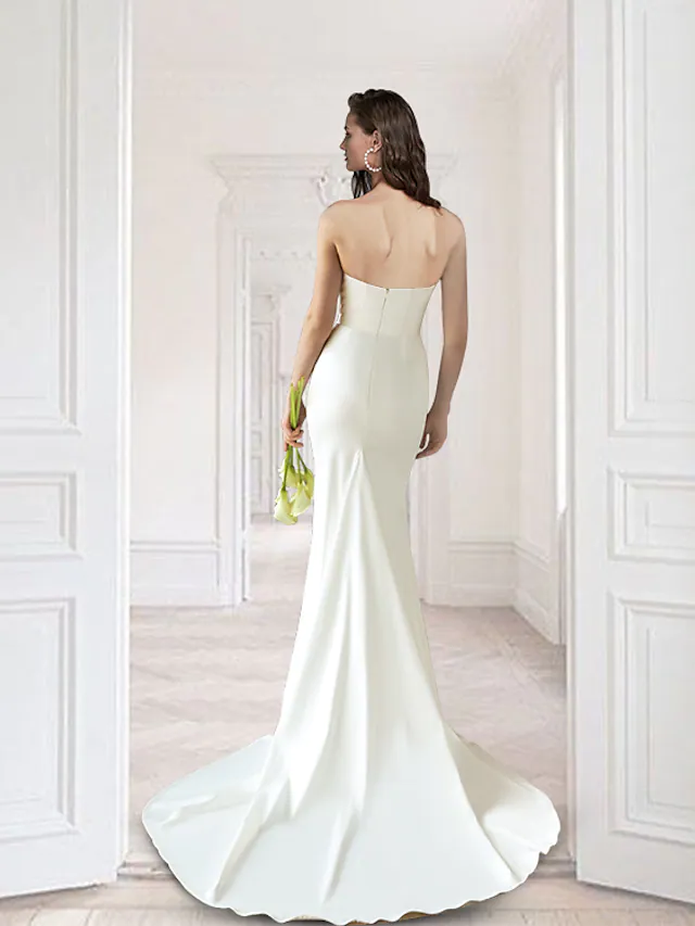 Back view of a sleeveless satin wedding gown with a detachable train.