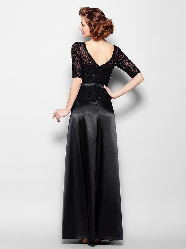 Close-up of the V-neckline and lace detailing on the half-sleeve Mother of the Bride dress.