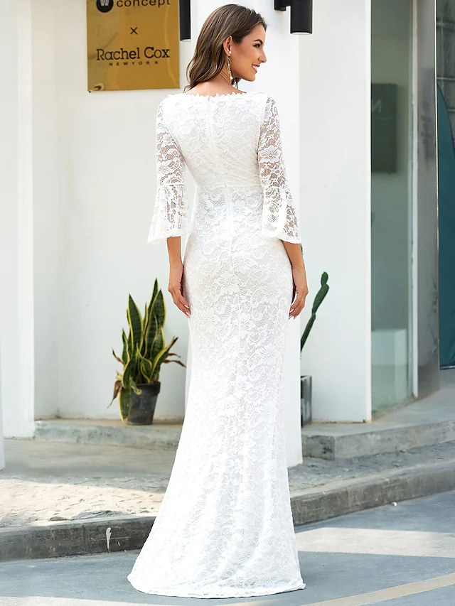 Side view of a bride wearing a mermaid-style wedding dress with lace details.