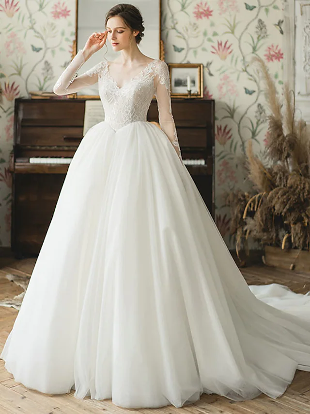 Elegant V-neck long sleeve ball gown wedding dress.