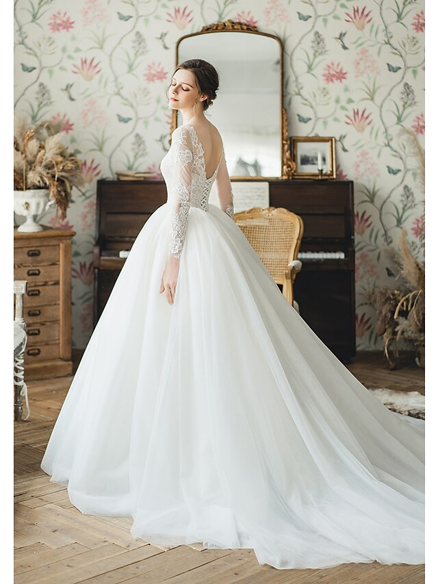 Back view of the long sleeve bridal gown with pleats.