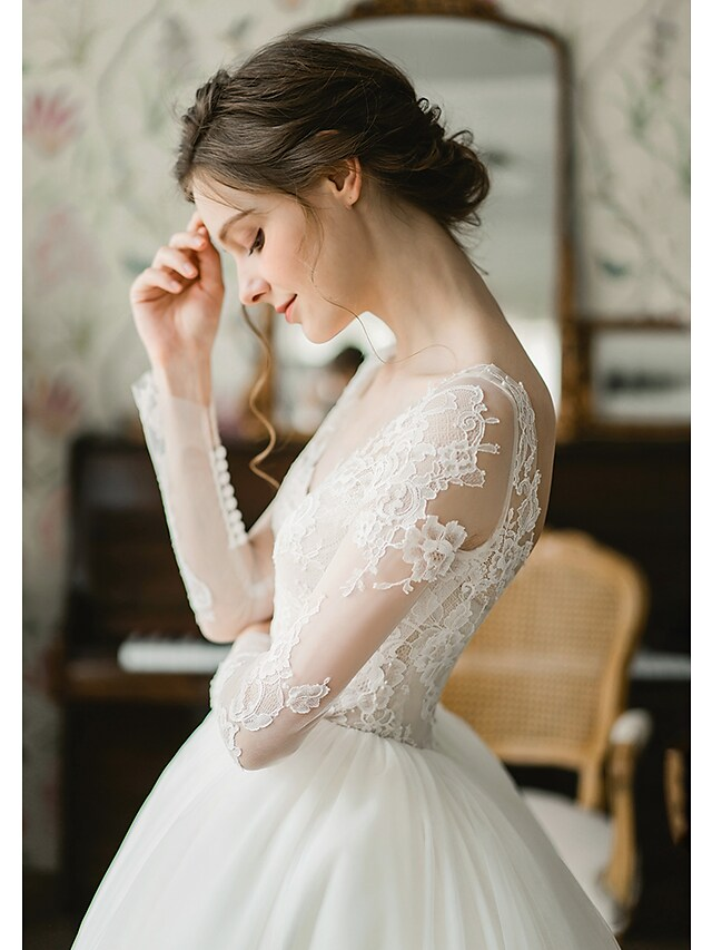 Bridal model wearing the formal V-neck long sleeve wedding dress.