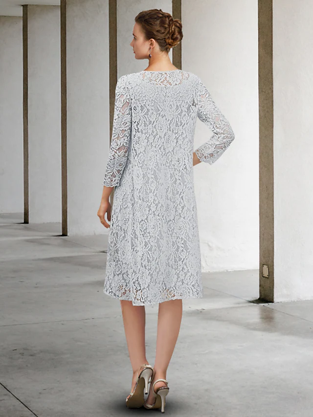 Side view of a knee-length chiffon lace mother of the bride dress.