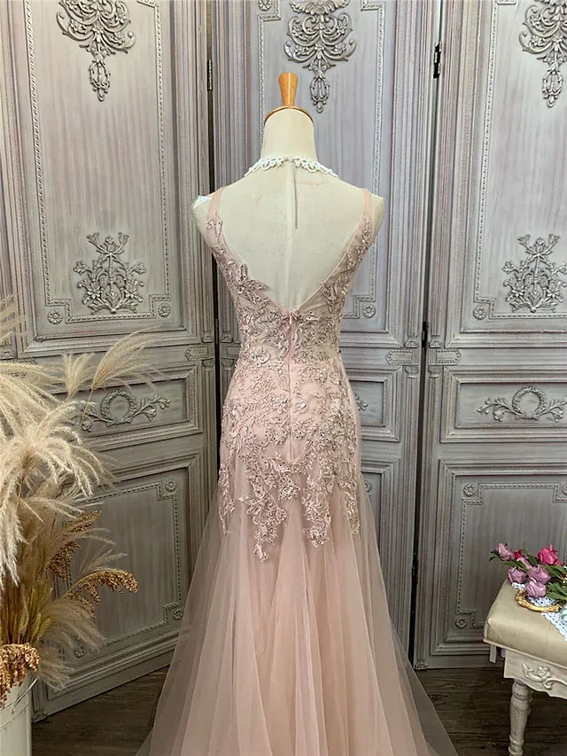 Close-up of the V-neckline and delicate appliques on the tulle fabric.