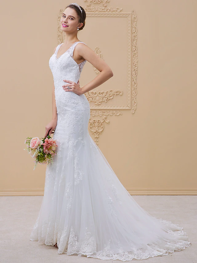 Elegant V-neck mermaid wedding dress with lace appliques.