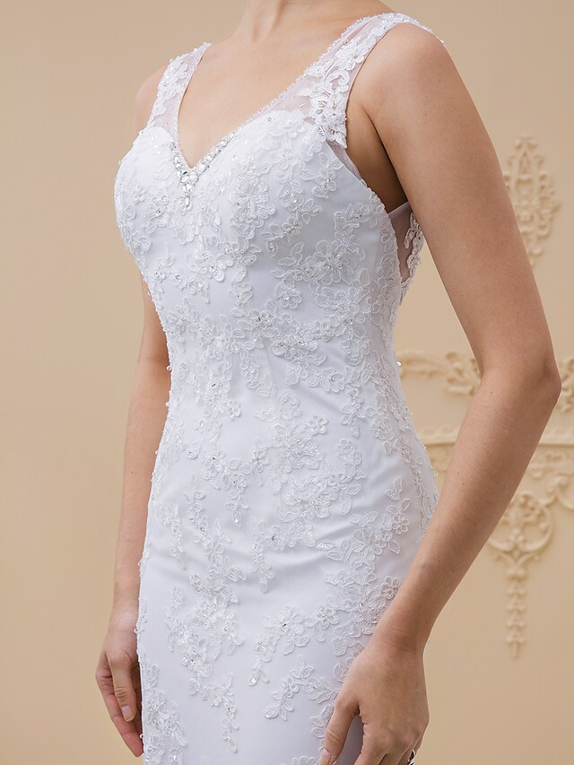 Detail of the chapel train and lace hem of the wedding dress.