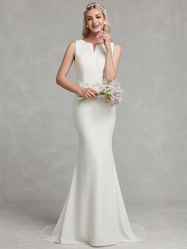 Close-up of appliques on V-neck wedding dress.