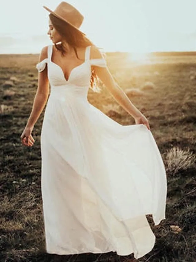 Model wearing an elegant V-neck short sleeve chiffon wedding dress with pleats.