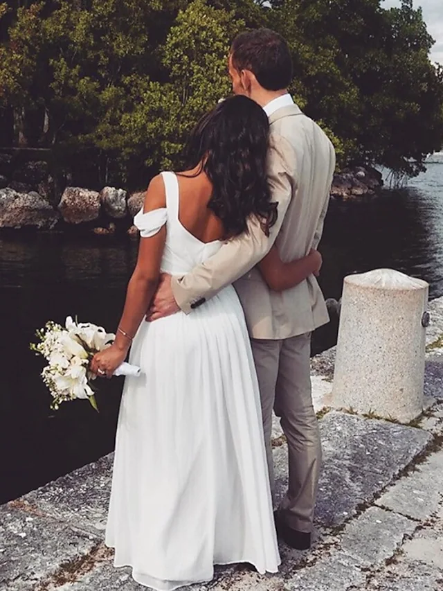 Back view of a floor-length chiffon wedding dress with elegant pleats.