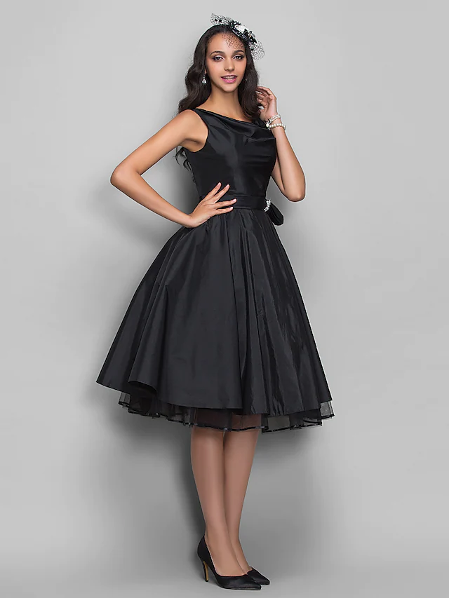 Back view of the sleeveless taffeta cocktail dress with crystal details.