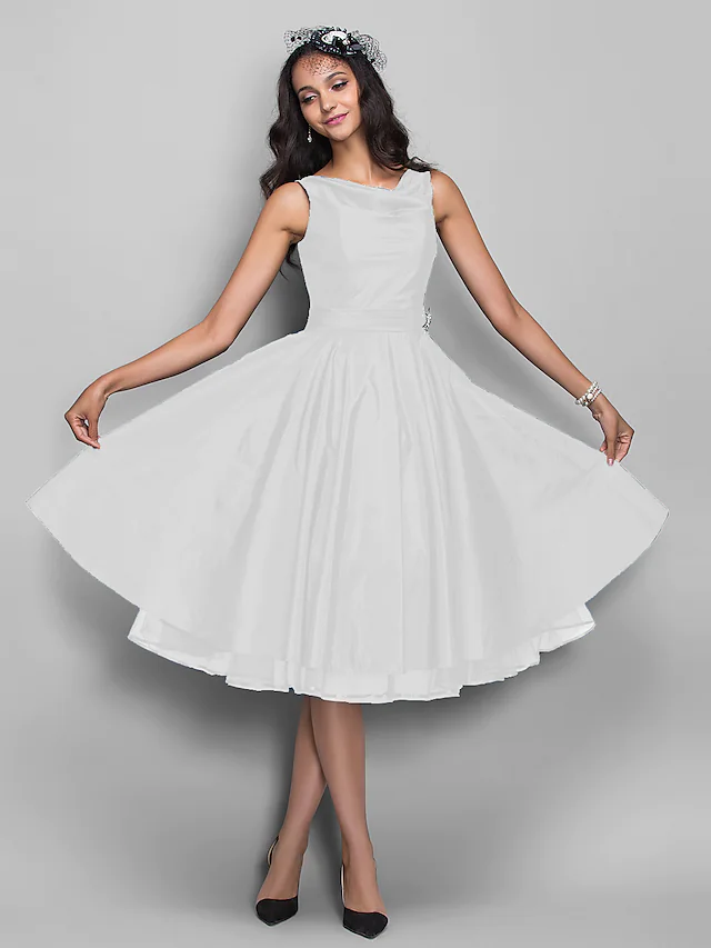 Model posing in the V-neck knee-length prom dress.