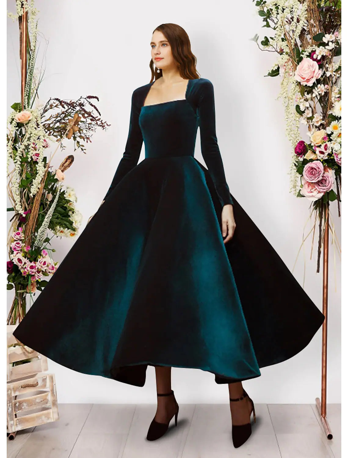 Elegant velvet ball gown with square neck and long sleeves.