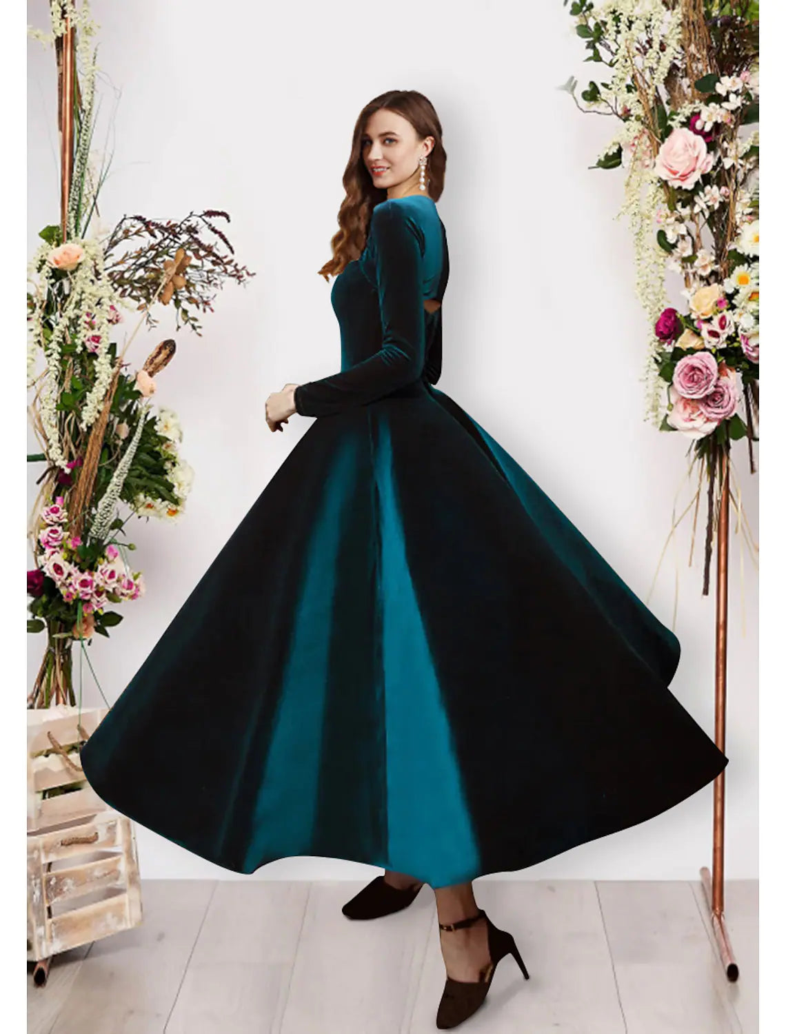 Woman posing in an ankle-length velvet evening dress.