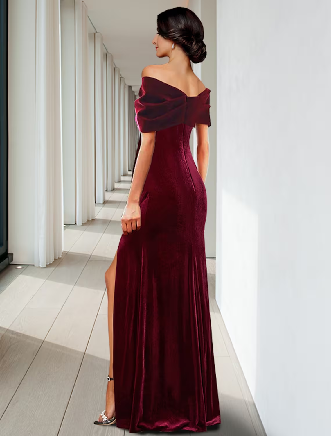 Back view of a sleeveless velvet evening gown with ruffled details.