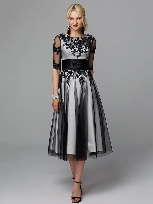 Elegant A-line tea length dress with jewel neck and half sleeves.