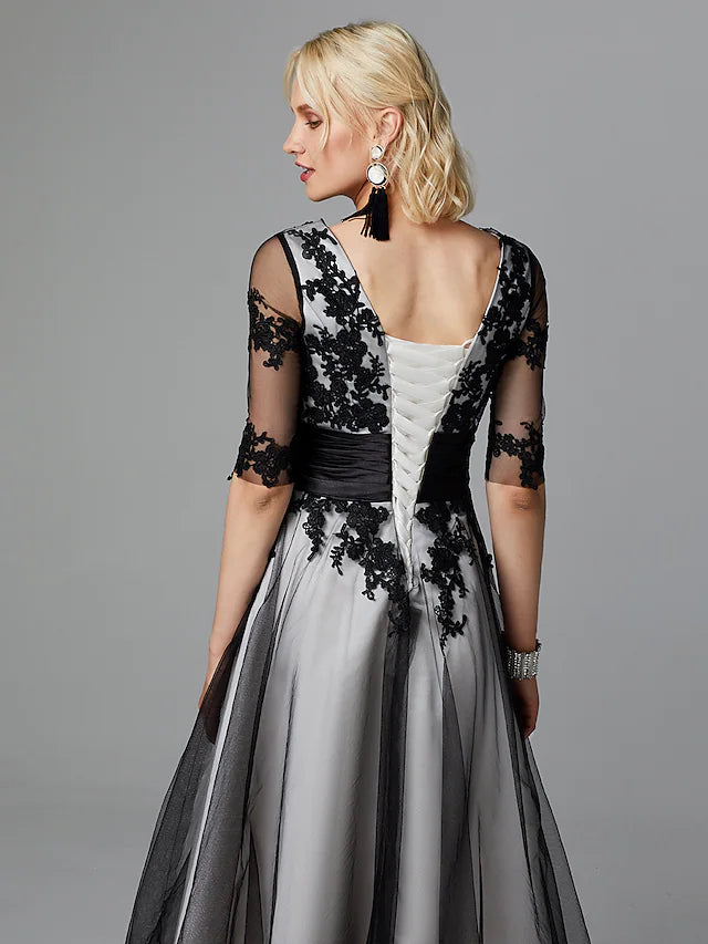 Close-up of delicate lace and sash detail on the dress.