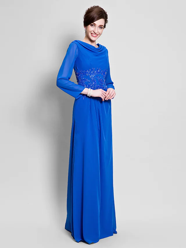 Woman wearing a vintage-inspired cowl neck chiffon mother of the bride dress with long sleeves and appliques.