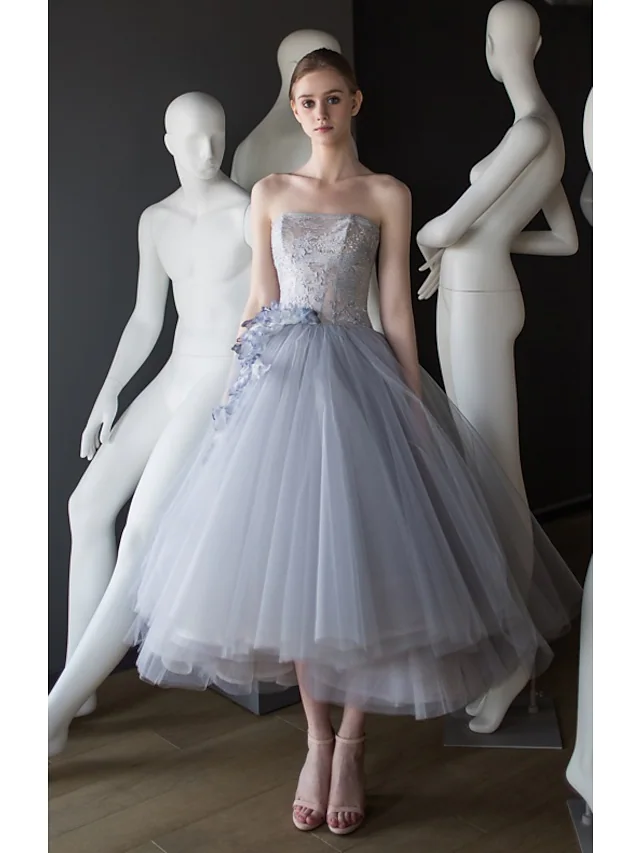 Elegant vintage strapless tulle ball gown with appliques, front view.