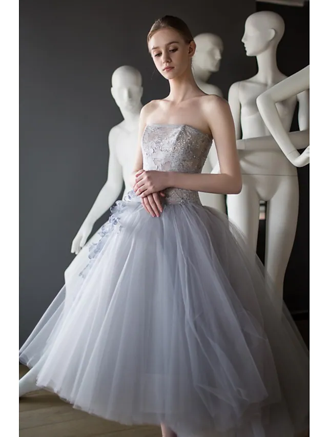 Side view of the elegant vintage strapless tea-length tulle dress.