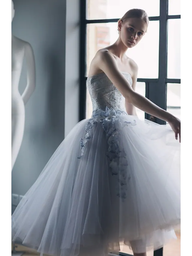 Back view of the strapless tea-length formal dress with tulle skirt.