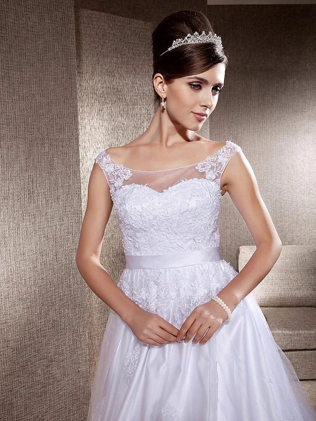 Detail of the lace bodice and scoop neckline of the wedding dress.