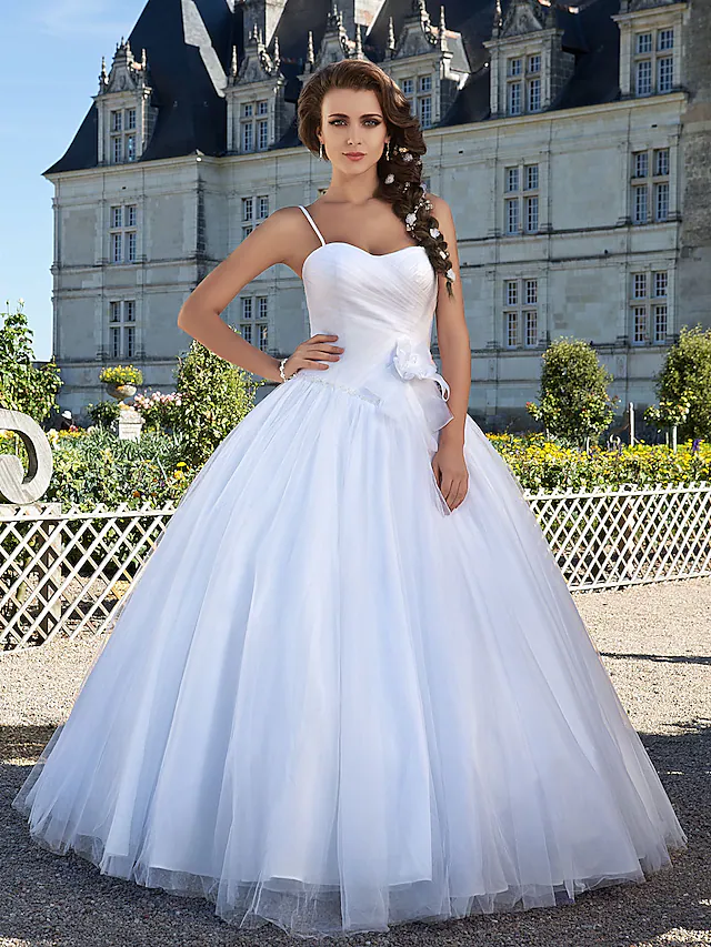 Elegant white ball gown wedding dress with sweetheart neckline.