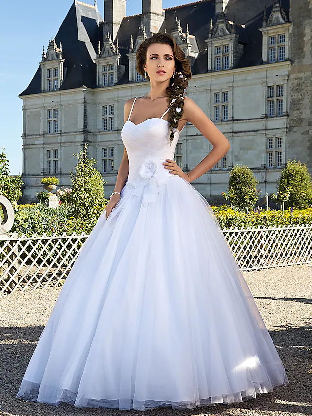 Close-up of the sweetheart neckline on a white wedding dress.