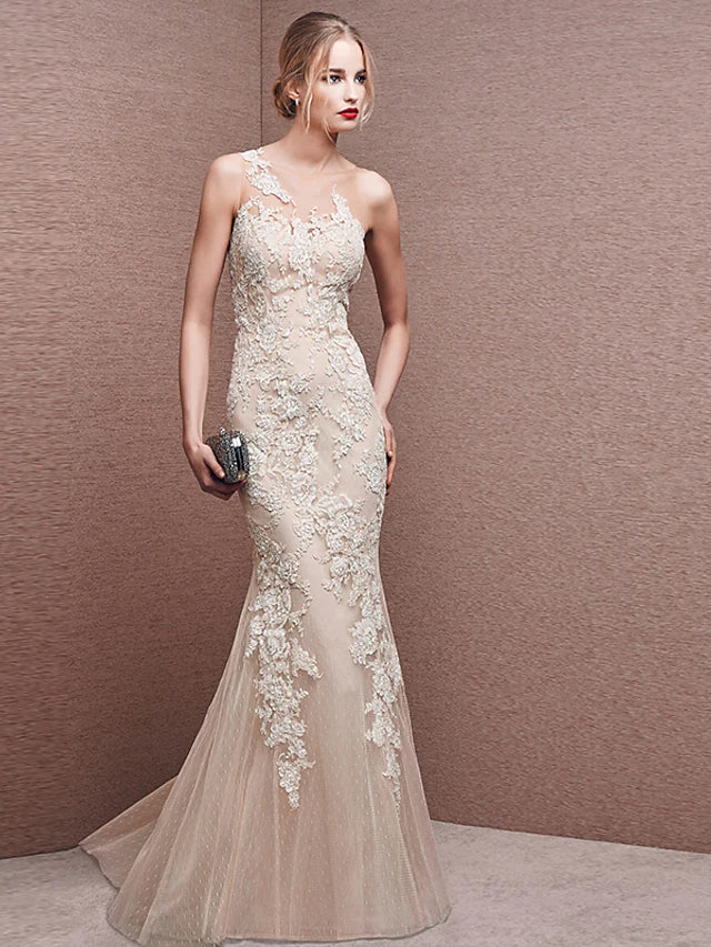 White mermaid trumpet evening dress with illusion neckline and lace appliques.