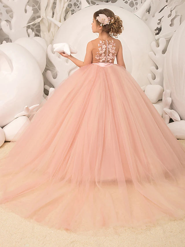 Back view of a white sleeveless flower girl dress with court train.