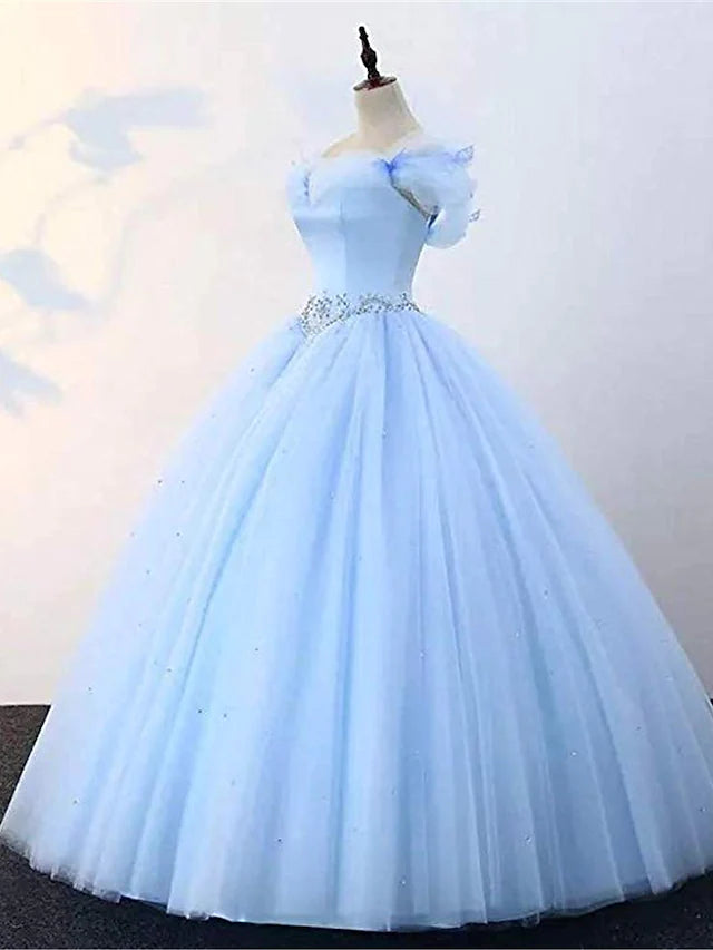 Side view of an elegant off-shoulder ball gown featuring pearl and butterfly embellishments.