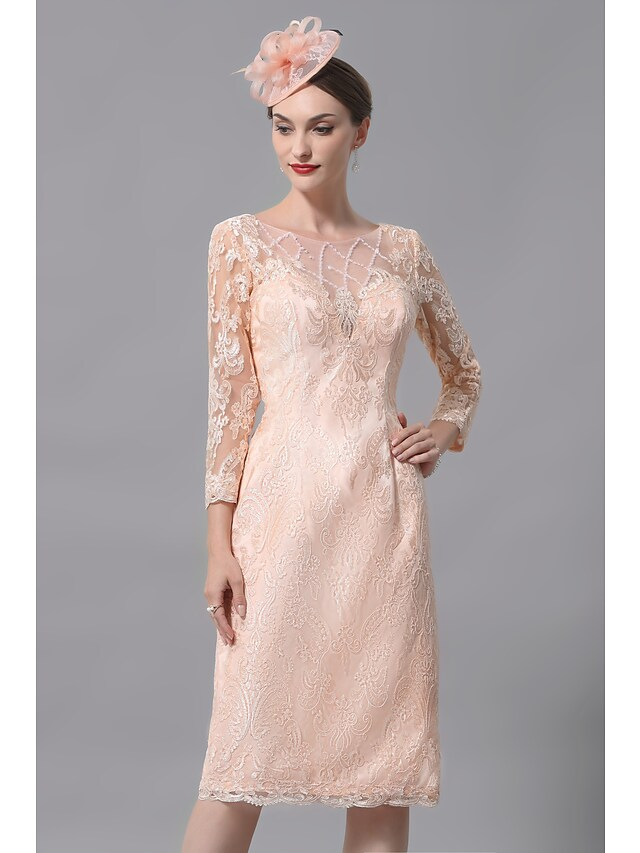 Full view of a woman wearing a knee-length Mother of the Bride dress.