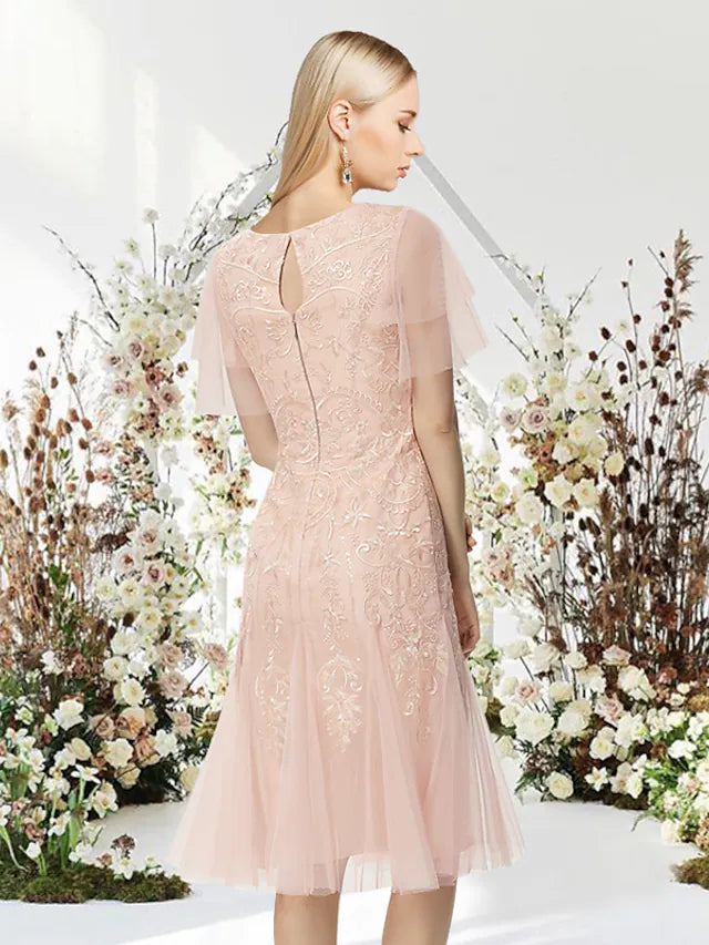 Side view of the knee-length A-Line dress, showcasing lace applique details.