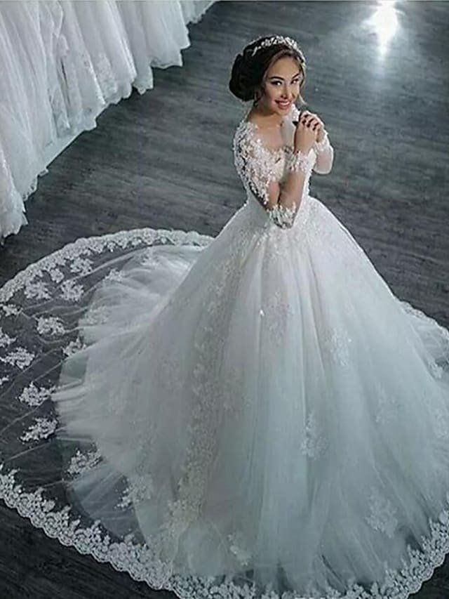 Full view of an A-Line high neck lace long sleeve wedding dress with a court train.