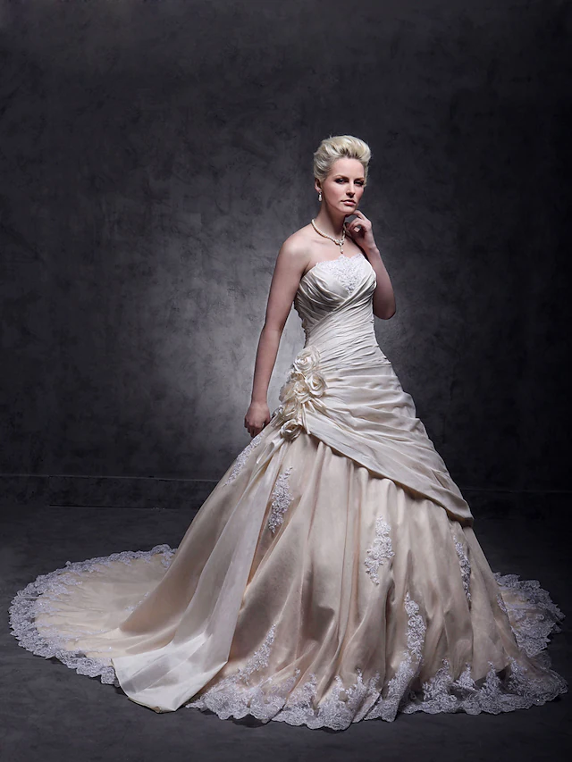 Glamorous A-Line strapless wedding dress with beaded lace.